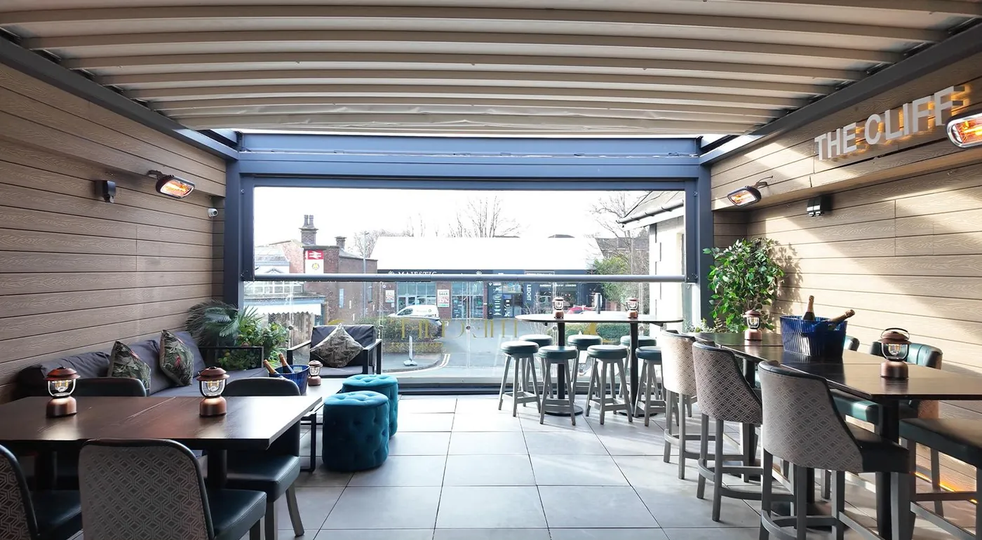 The covered rooftop terrace with lounge seating and high tables